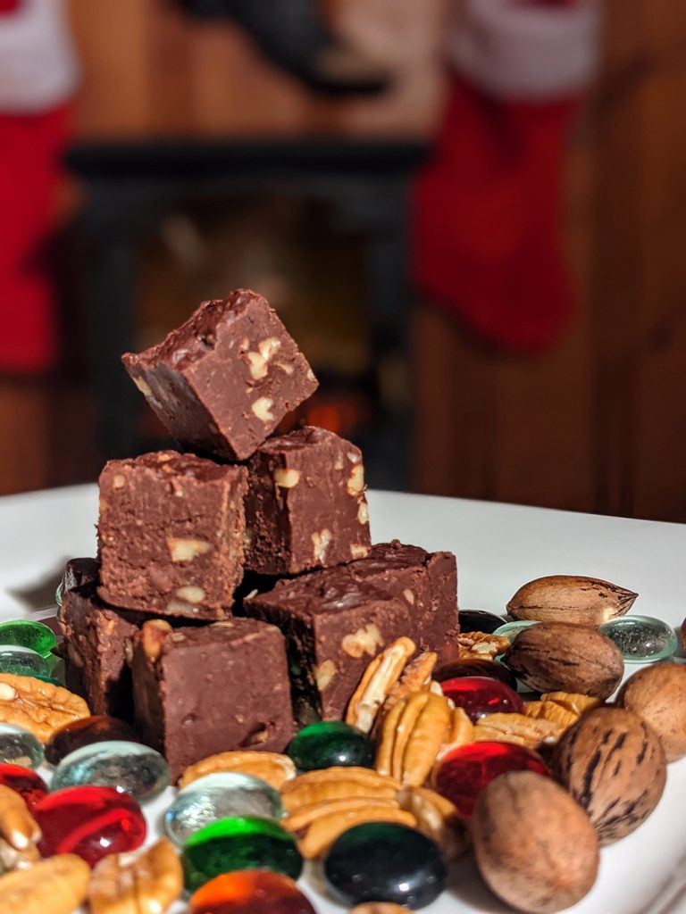 Pecan fudge with stockings in background